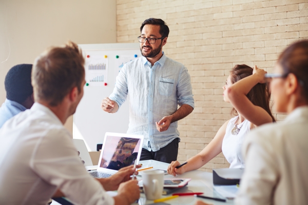 Group of people in front of white board 