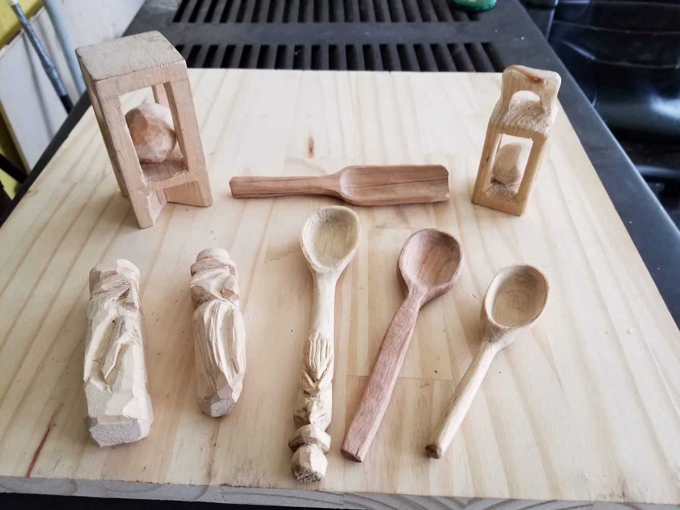 Carving Spoons - several examples on a wood table - Continuing Education at Seattle Central College 