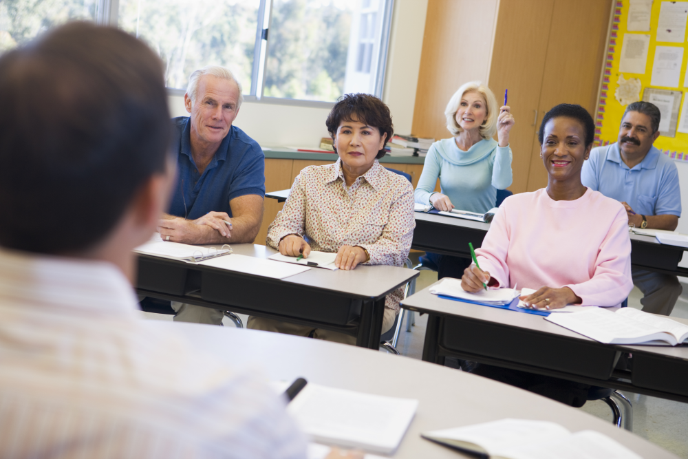 Classroom of mature students at desks 