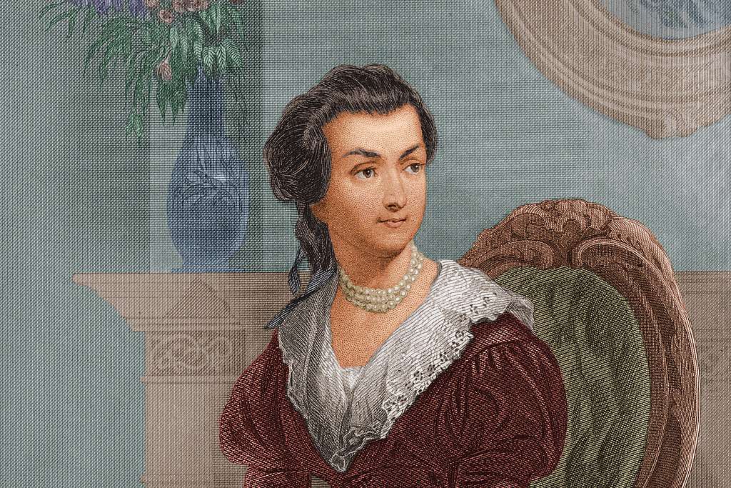Color portrait painting of Abigail Adams, a woman sitting in chair by Christian Schussele. 