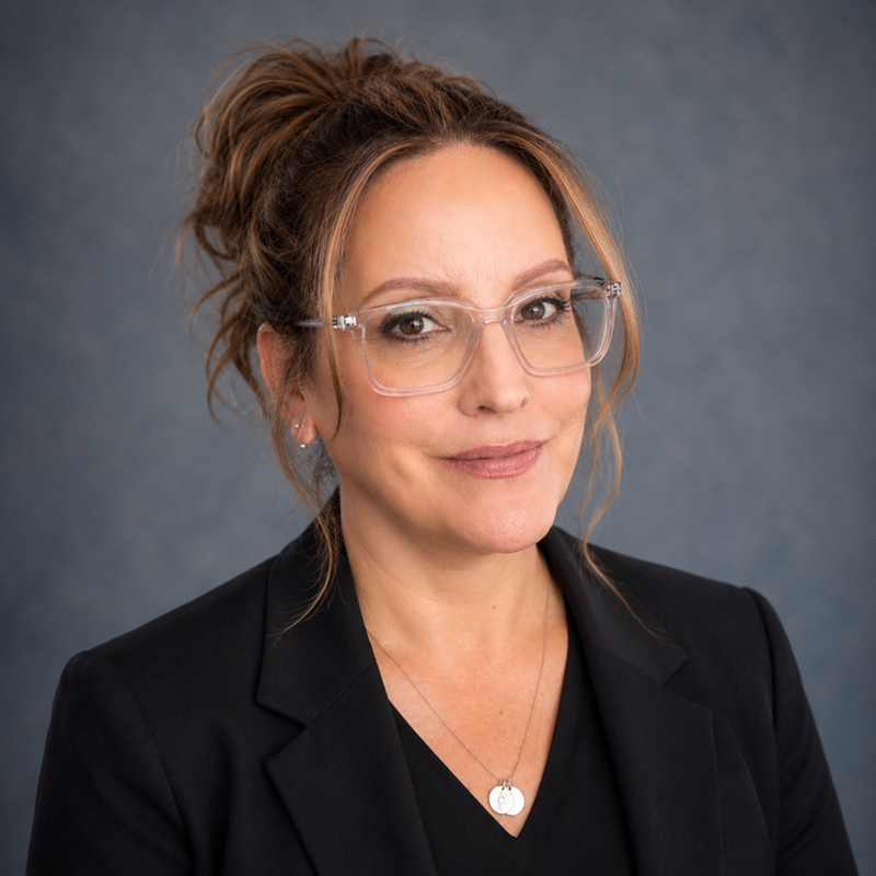 Headshot of Rachael St. Clair, a light skinned woman with brown hair up on her head and glasses.