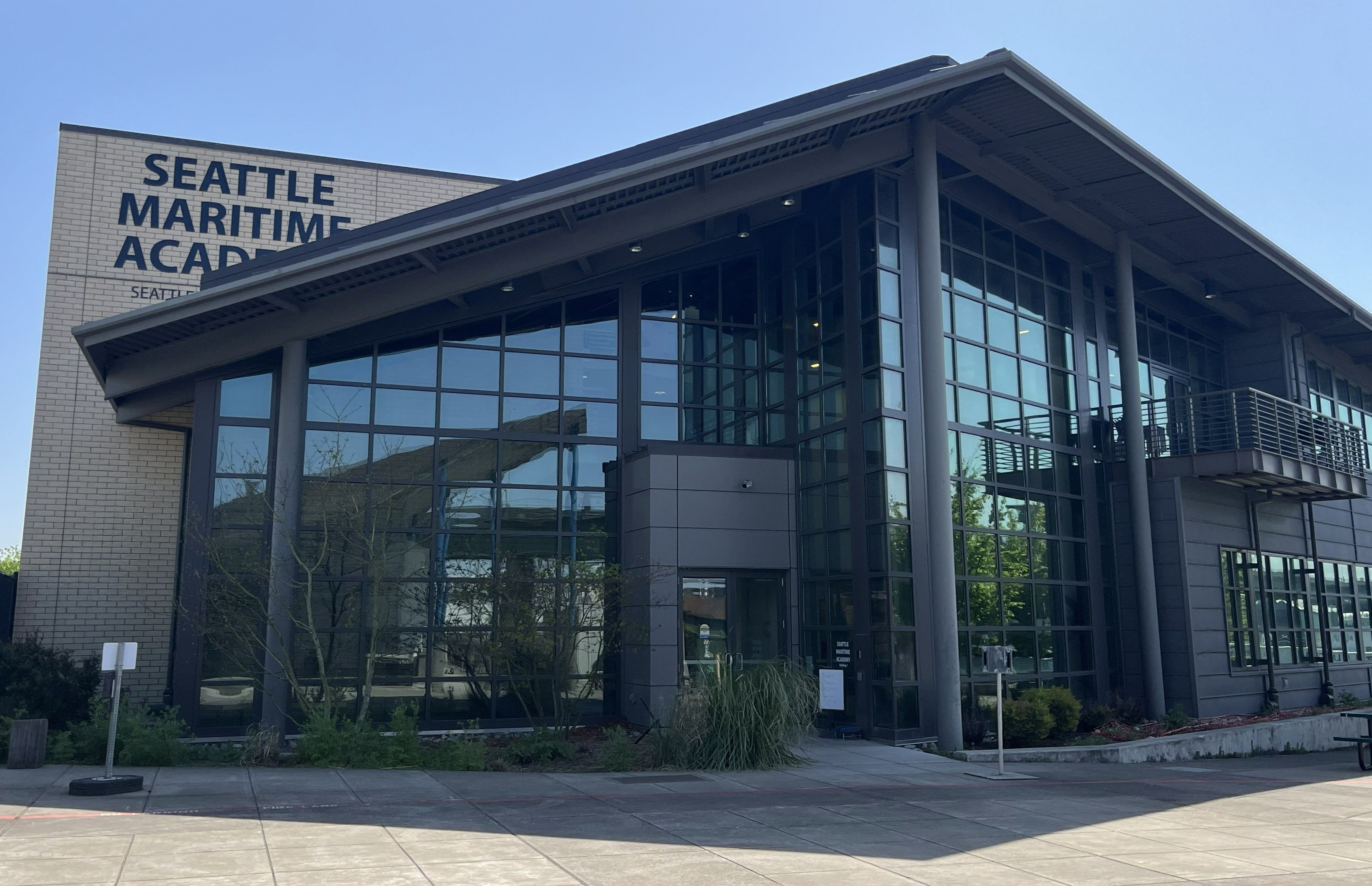 The Seattle Maritime Academy building with a two-story peaked portico entrance and mirror glazing for most of the front. 